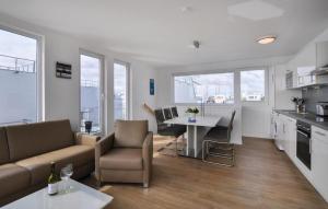 een keuken en woonkamer met een bank en een tafel bij Hausboot in Olpenitz