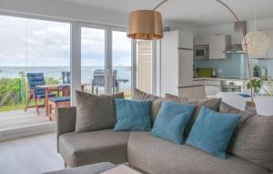 a living room with a couch and a view of the ocean at Fiete in Olpenitz