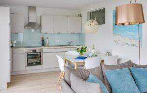 a kitchen and dining room with a table and chairs at Fiete in Olpenitz