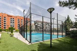 a fence around a swimming pool in a city at Holiday Granada Ático Piscina y Parking in Granada