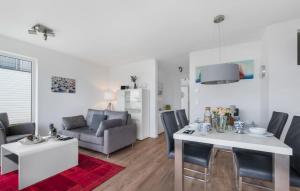 a living room with a table and a couch at Baltica in Olpenitz