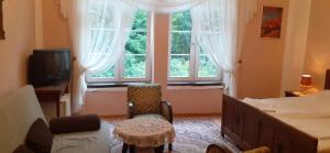 a bedroom with a bed and a large window at Pałac Stanica in Przeworno