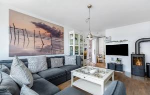 a living room with a couch and a tv at Traumfänger in Olpenitz