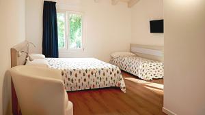Postel nebo postele na pokoji v ubytování Residence Duna Rossa - Family Friendly