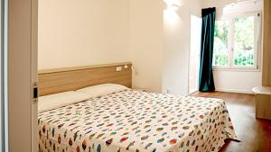 Postel nebo postele na pokoji v ubytování Residence Duna Rossa - Family Friendly