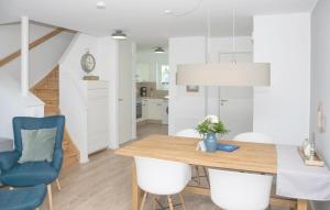 a kitchen and dining room with a table and chairs at Achtern Schilf in Olpenitz +14 photos