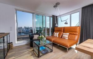 a living room with a couch and a glass table at 10 Ost in Olpenitz