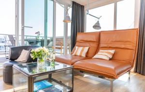 a living room with a couch and a glass table at 10 Ost in Olpenitz +14 photos