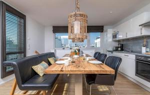 a dining room with a wooden table and black chairs at 10 Ost in Olpenitz
