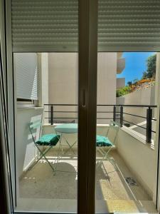 a balcony with two chairs and a table and a window at One bedroom Apartment 777 in Budva