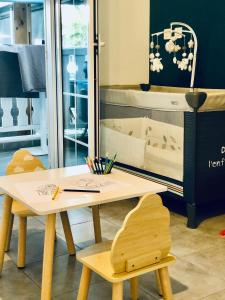a wooden table with two chairs and a mirror at Lindsey Hôtel in Saint-Pierre