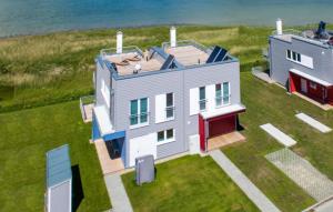an aerial view of a house with the ocean in the background at Villa Kunterbunt in Olpenitz
