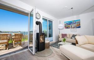 a living room with a fireplace and a view of the ocean at Villa Kunterbunt in Olpenitz