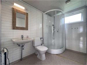 a bathroom with a shower and a toilet and a sink at Selje Camping - Hytte Nr 4 in Selje