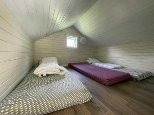 two beds in a room in a attic at Selje Camping - Hytte Nr 4 in Selje +5 photos
