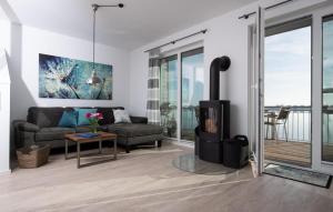 a living room with a couch and a fireplace at Lillehuus in Olpenitz