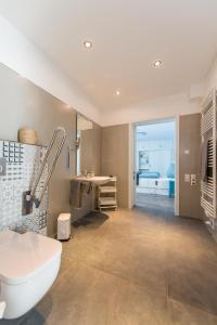 a bathroom with a white tub and a sink at Ferienwohnung 2 (rollstuhlgerecht), Hoddersdiek 1 in Hoddersdeich