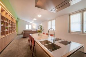 a kitchen with a sink and a living room at JOIVY Charming Portofino 3-bed retreat in Portofino