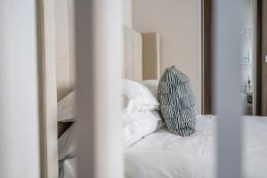 a white bed with a pillow on top of it at Cocoa Loft - parking included in York
