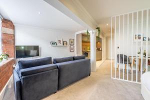 a living room with a couch and a television at Cocoa Loft - parking included in York
