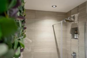a shower with a glass door in a bathroom at Cocoa Loft in York