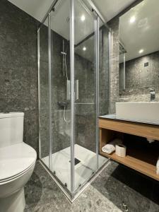a bathroom with a shower and a toilet and a sink at Sunflower Hotel Apartments in Larnaka