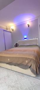 a bedroom with a large bed with a blue light at Modern design house in the heart of Marmaris in Marmaris