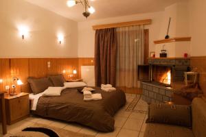 A bed or beds in a room at La Petri Studios with Fireplace & View