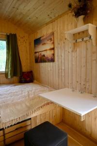a room with a bed in a wooden cabin at Bienenwagen Weitblick, Kamin, Sauna ganzjährig nutzbar in Dargun +33 photos