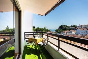 un balcone con tavolo e sedie e vista di Bela Vista in Almada Velha ad Almada