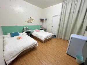 Postel nebo postele na pokoji v ubytování Chaonima B&B 潮尼馬民宿