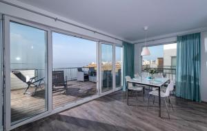 a living room with a table and chairs on a balcony at Flamingo in Olpenitz