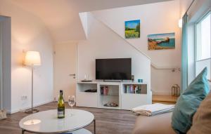 a living room with a couch and a tv at Kolibri in Olpenitz