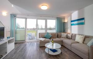 a living room with a couch and a table at Kolibri in Olpenitz