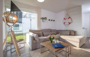 a living room with a couch and a table at B-Lodge in Olpenitz