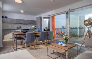 a kitchen and living room with a table and chairs at B-Lodge in Olpenitz