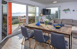 a living room with a wooden table and chairs at B-Lodge in Olpenitz