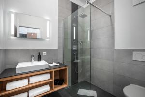 a bathroom with a sink and a shower at Landhotel Grüner Wald in Neuhausen