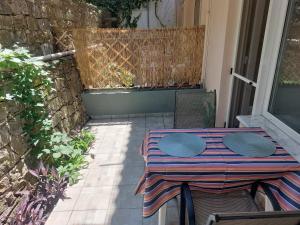 a table and chairs sitting on a patio at Samos Cozy Apartment in Samos
