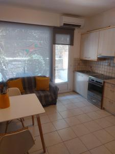 a kitchen and living room with a couch and a table at Samos Cozy Apartment in Samos