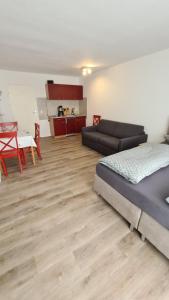 a living room with a bed and a couch at Urlaub in Bayerischen Wald in Sankt Englmar