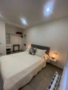 a bedroom with a large white bed with two pillows at APARTAMENTOS EL ROJU in Santillana del Mar