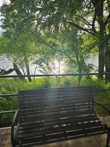 eine Parkbank mit Blick auf das Wasser in der Unterkunft Auto kamp Hacienda Kolenda in Mostar