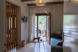 a living room with a couch and a table at Sea side in Pteleós