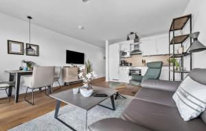 a living room with a couch and a table at Segler Nest in Olpenitz