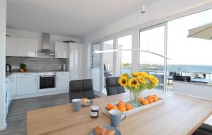a kitchen with a table with oranges and flowers on it at Wilbur in Olpenitz +24 photos