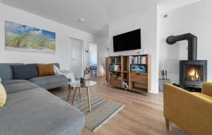 a living room with a couch and a fireplace at Strand 11 in Olpenitz