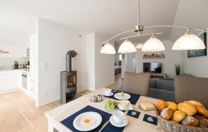 a dining room and living room with a table with food at Windrose in Olpenitz