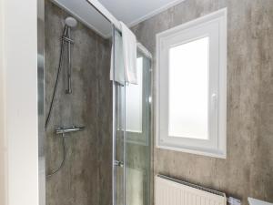a bathroom with a shower and a window at Chalet in Middelkerke near the Beach in Middelkerke +32 photos