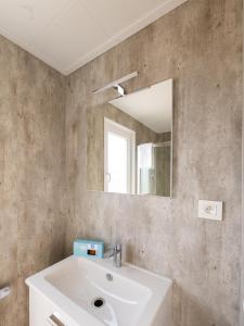 a bathroom with a sink and a mirror at Chalet in Middelkerke near the Beach in Middelkerke